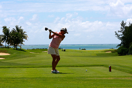 woman in pink sleeveless shirt plating golf at daytime