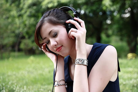 woman listening to music while wearing headphones