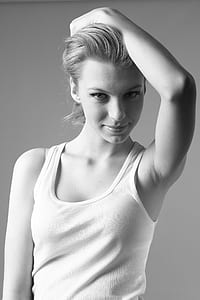 gray scale of woman wearing a white tank top