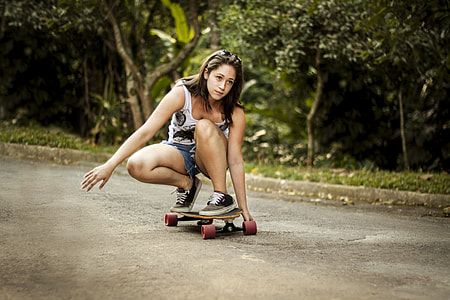 woman riding skateboard during daytime