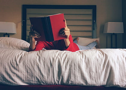 person reading white on bed
