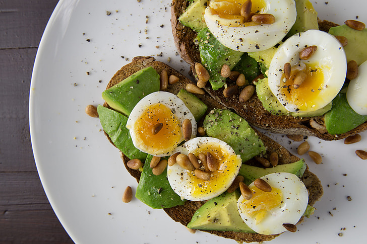 Soft-boiled eggs and avocado on toasted walnut bread