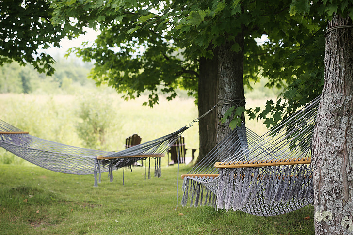two gray hanging hammocks