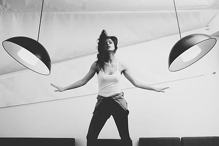 woman flipping hair between two pendant lights
