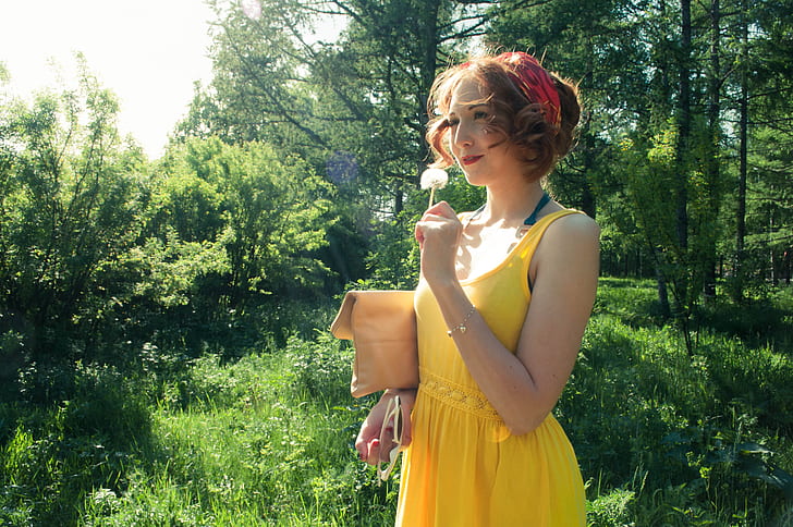 woman in yellow sleeveless dress near forest during daytime