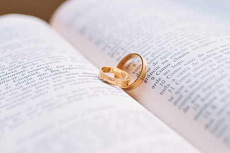two gold-colored rings on book