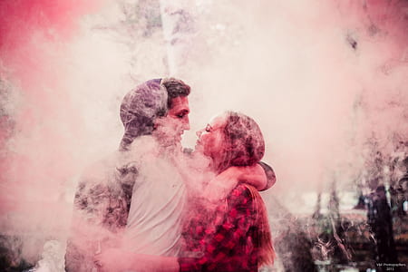 man and woman facing each other surrounded with smoke