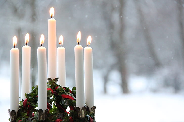 white candle on snow