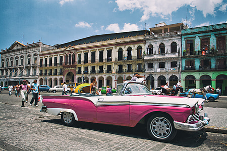A pink Cadillac car sits on the colourful and vibrant streets of Havana in Cuba, the unofficial capital of Latin America. This image was captured with a Canon DSLR