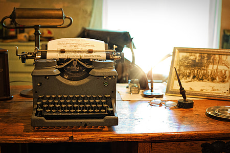 vintage gray typewriter on brown wooden table