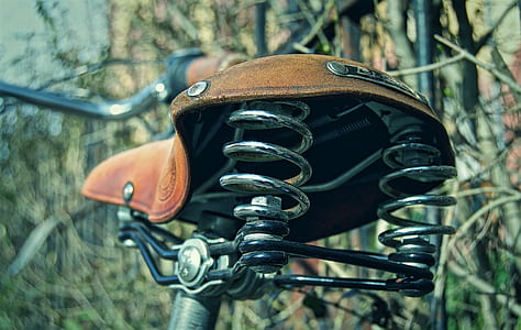 brown bicycle saddle with stainless steel spring