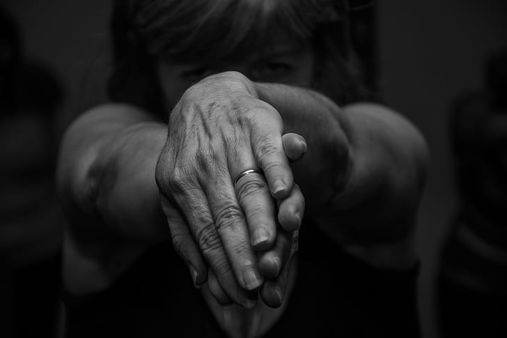 grayscale photography of woman twisting both hands