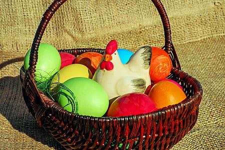assorted-color eggs in brown basket