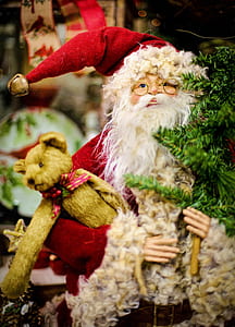 macro photography of ceramic Santa Claus holding bear figurine