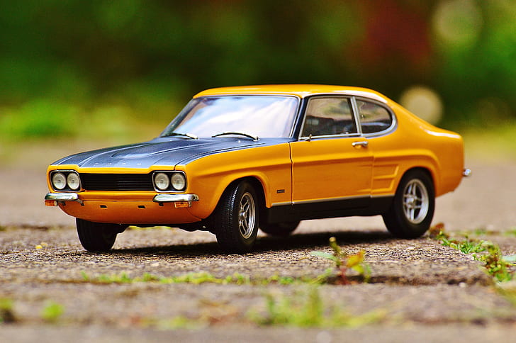 selective focus photo of classic yellow coupe scale model