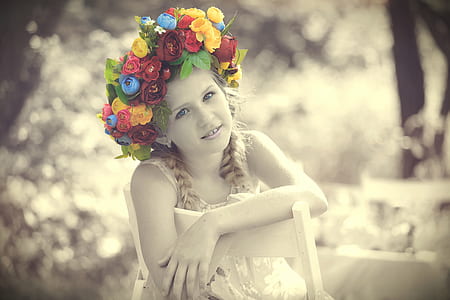 girl sitting in the chair with flower headdress