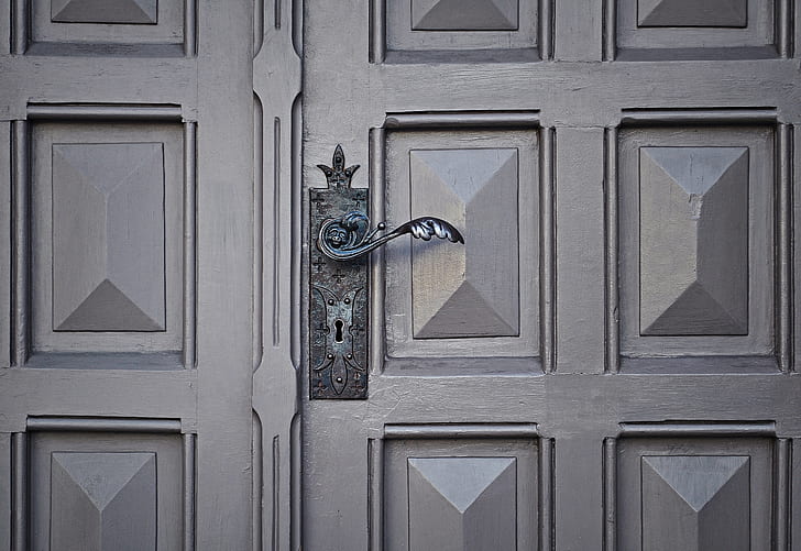 gray door handle on gray panel door