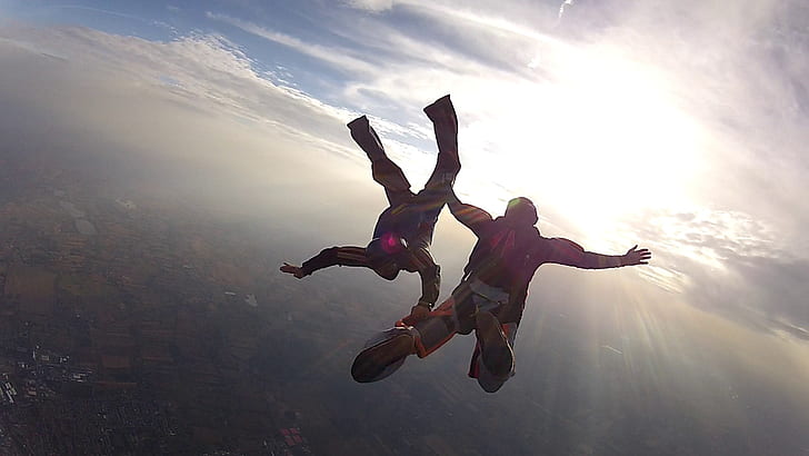 two person sky diving during daytime