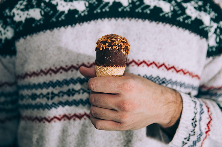 person's hand holding an ice cream