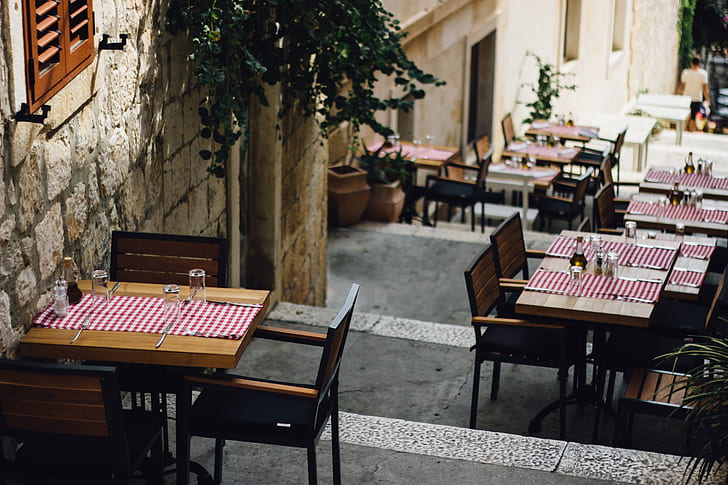 brown wooden tables along the street during daytime