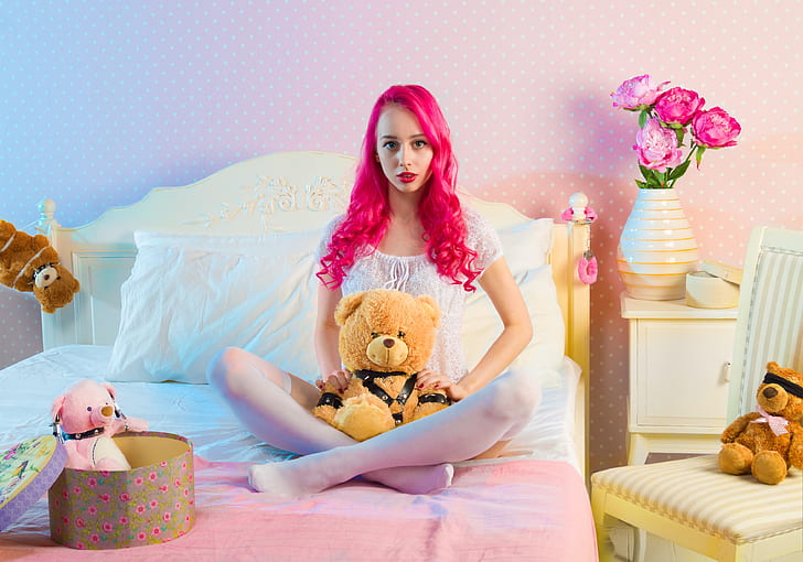 woman with pink hair and brown bear plush toy ]
