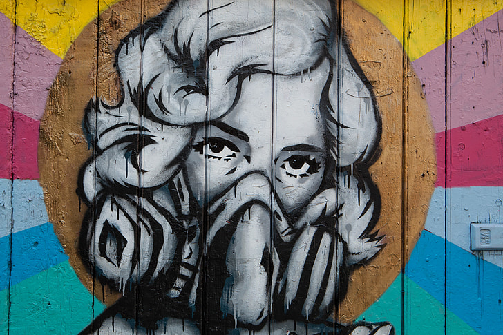 Street art depicting a woman wearing a mask captured on a wall in Shoreditch, East London. Image taken with a Canon DSLR