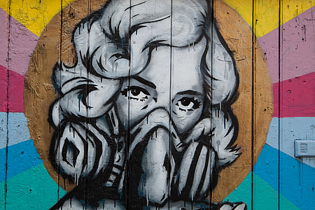 Street art depicting a woman wearing a mask captured on a wall in Shoreditch, East London. Image taken with a Canon DSLR