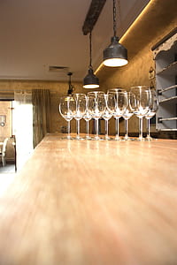 clear wineglasses on brown wooden table
