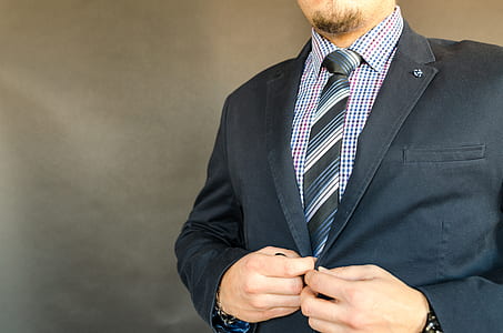 man wearing black notched lapel suit jacket