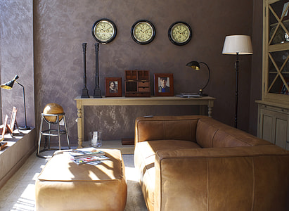brown leather sofa and ottoman inside room