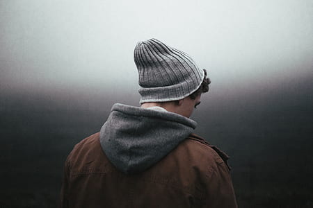 person wearing brown and gray hoodie and gray beanie