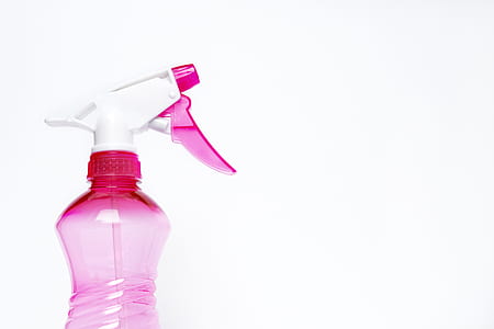 pink and white plastic spray bottle