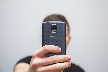 person holding black Samsung smartphone