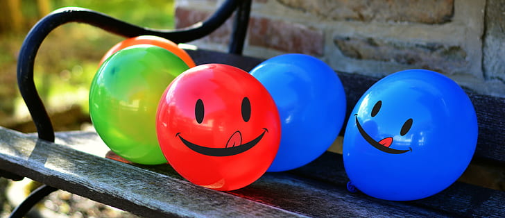 assorted balloons on patio bench