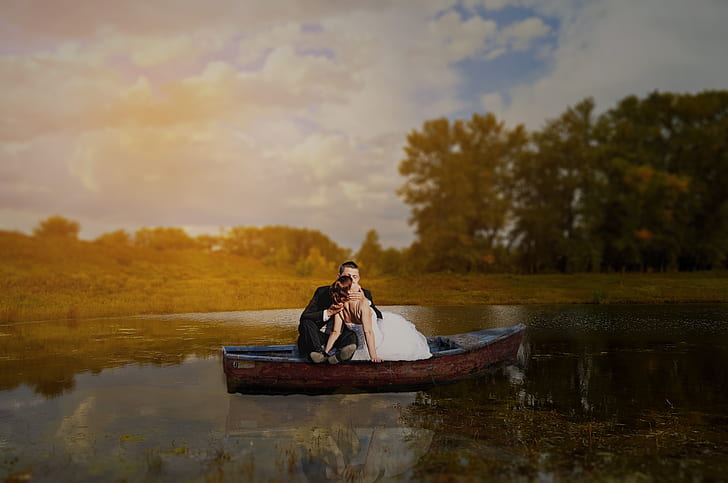 man and woman on brown wooden boat