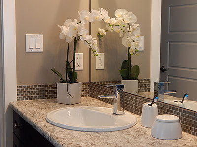 white ceramic sink beside white Orchid flower