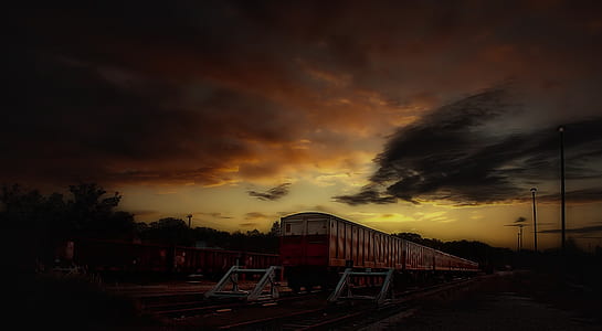 Red and White Train Taken during Sunset