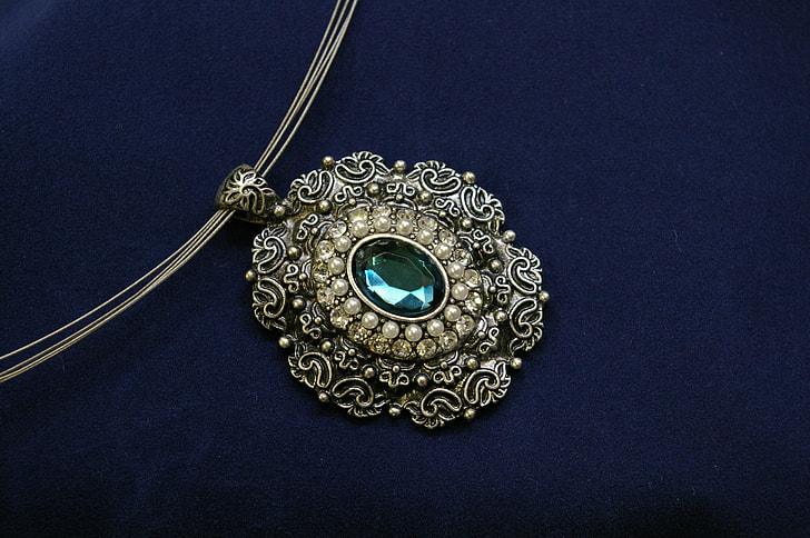 oval silver-colored green gemstone pendant necklace