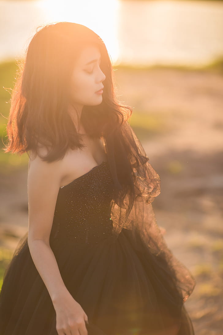 shallow focus photography of woman in black strapless dress
