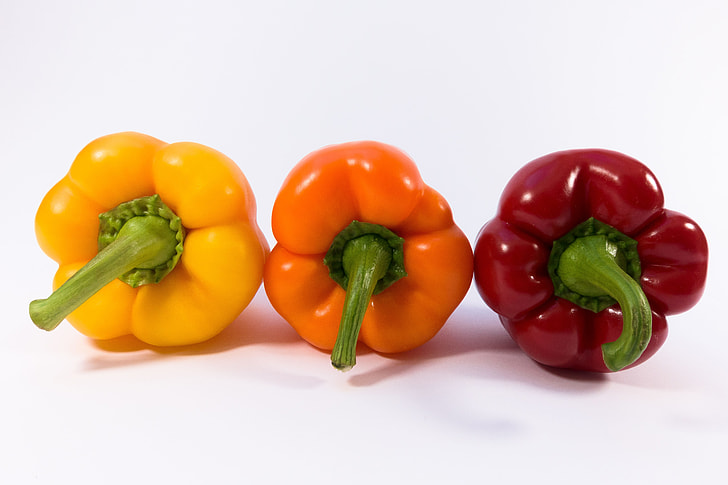 three assorted-color of bell peppers with white background