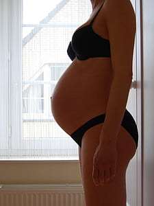 woman showing her baby bump photo