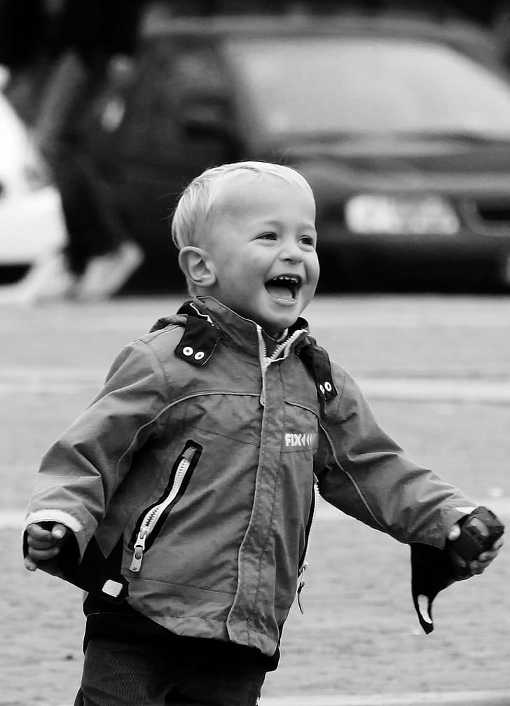 grayscale photo of toddler in jacket