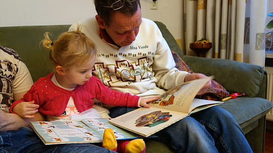man and child reading books