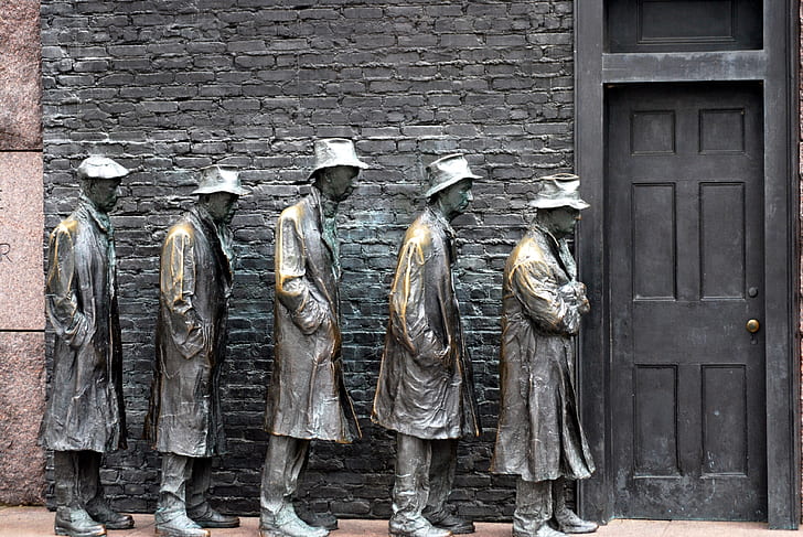 five men statue lining up near door photo
