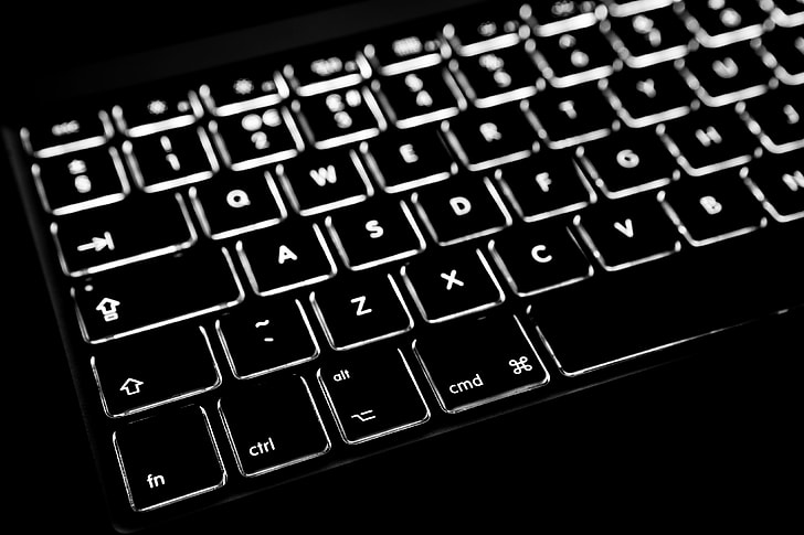 Close-up shot of the backlit keyboard from a laptop computer