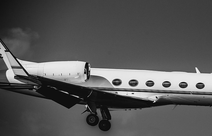 grayscale photo of an airplane on midair