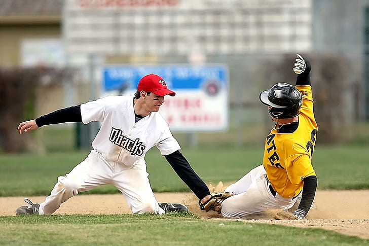 Royalty-Free photo: Baseball player kid wearing red and white jersey shirt  with white pants outfit