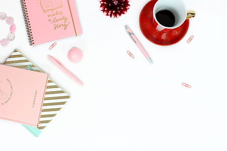 red teacup and pink note books