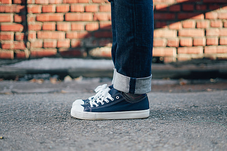 person wearing blue-and-white low-top sneakers