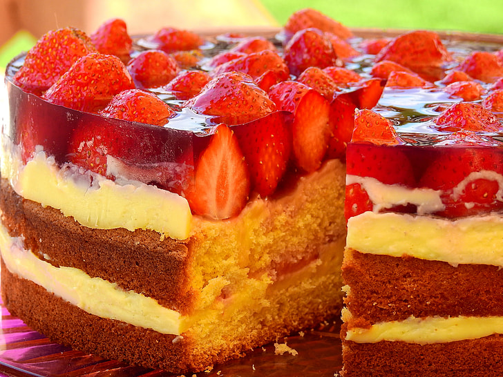 brown and white cake with strawberry toppings
